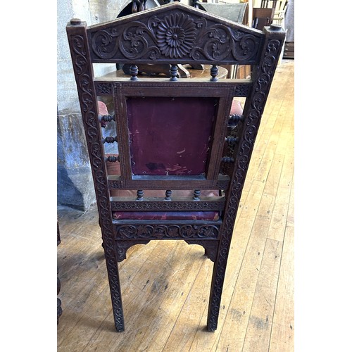 1009 - A pair of Anglo Indian carved walnut armchairs, with padded back, arms and seat, carved with foliate... 