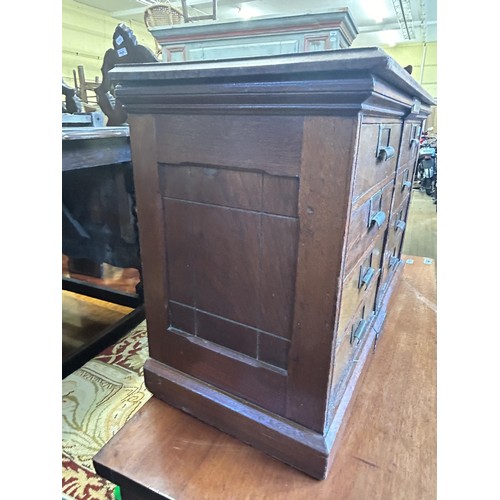 1043 - An unusual Canadian walnut filing cabinet, having eight drawers, with brass plaque reading Hart &... 