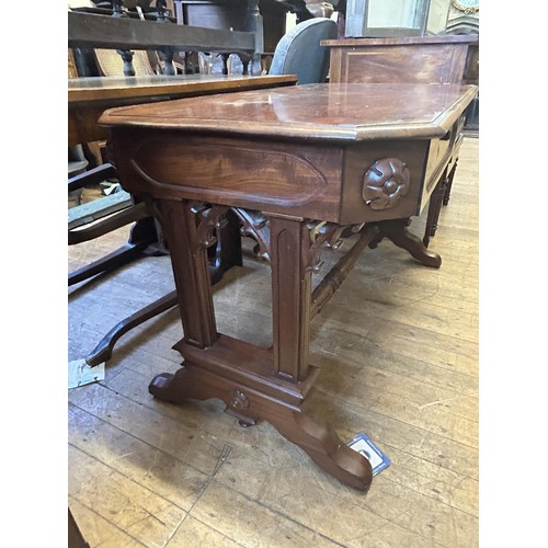 1044 - A mahogany Gothic Revival library table, having two frieze drawers, on carved twin end supports, 123... 