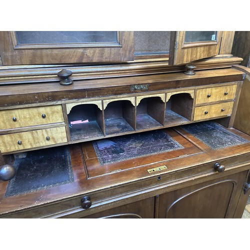 952 - A 19th century mahogany cylinder bookcase cabinet, the top having two glazed doors, above a cylinder... 