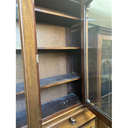 952 - A 19th century mahogany cylinder bookcase cabinet, the top having two glazed doors, above a cylinder... 