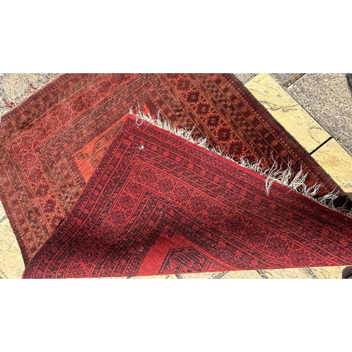 956 - An Afghan red ground rug, 180 x 135 cm