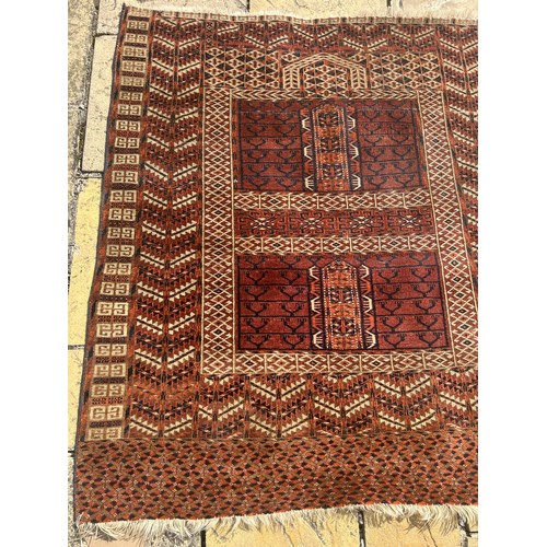 957 - A Persian type red ground rug, 140 x 125 cm