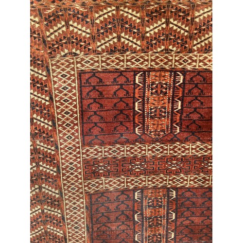 957 - A Persian type red ground rug, 140 x 125 cm