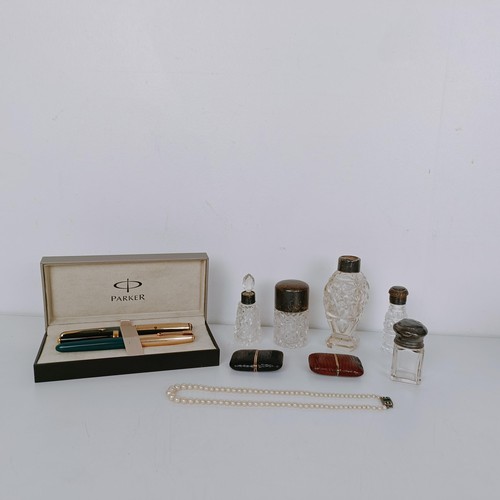 917 - A Parker fountain pen, two other fountain pens, two watch cases, five cut glass bottles with silver ... 