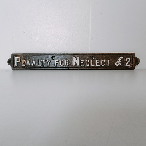 845B - A painted cast iron sign, Penalty For Neglect £2, 53 cm wide