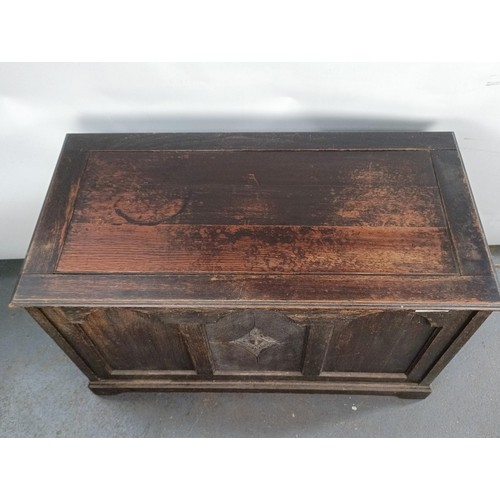 4 - An oak coffer, the front carved pomegranate, 126 cm wide