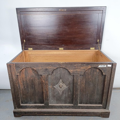 4 - An oak coffer, the front carved pomegranate, 126 cm wide