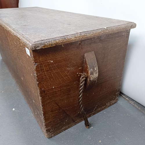 10 - A pine coffer, with rope handles, hinged top to reveal a candle box, 118 cm wide