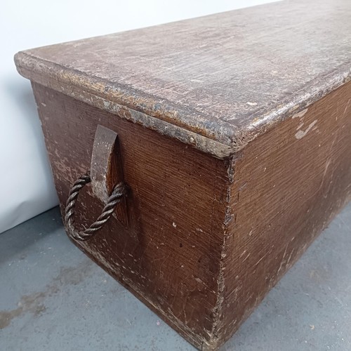 10 - A pine coffer, with rope handles, hinged top to reveal a candle box, 118 cm wide