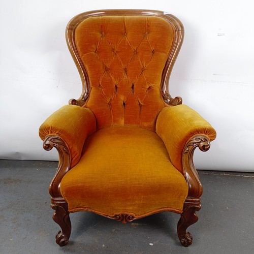 11 - A Victorian mahogany framed button back armchair