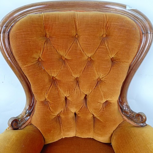 11 - A Victorian mahogany framed button back armchair