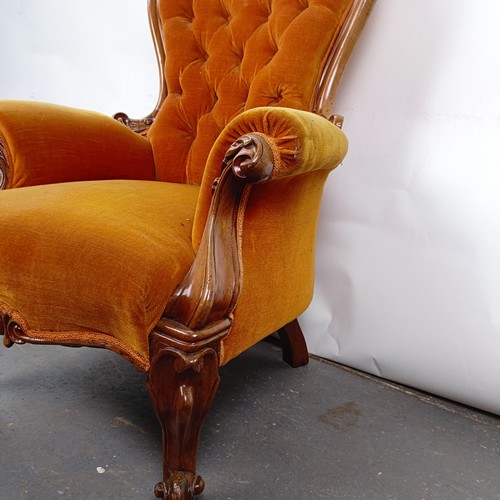 11 - A Victorian mahogany framed button back armchair