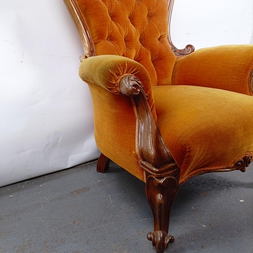 11 - A Victorian mahogany framed button back armchair