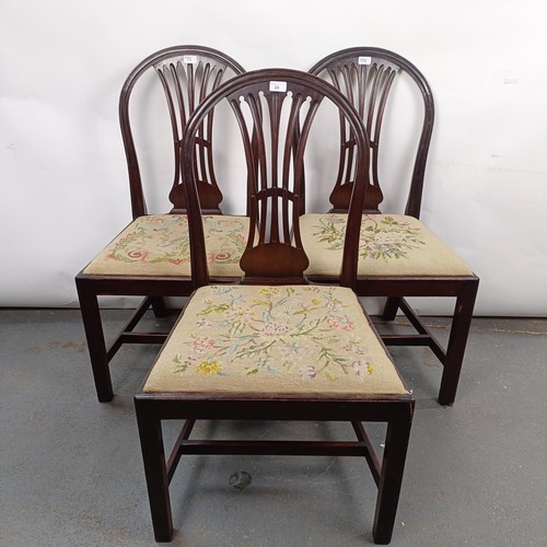 20 - A set of three mahogany hoop back dining chairs, with tapestry drop in seats