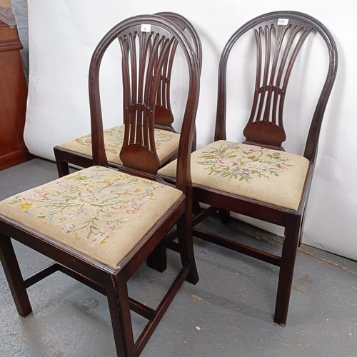 20 - A set of three mahogany hoop back dining chairs, with tapestry drop in seats