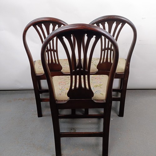 20 - A set of three mahogany hoop back dining chairs, with tapestry drop in seats