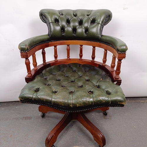 22 - A mahogany and green leather desk chair