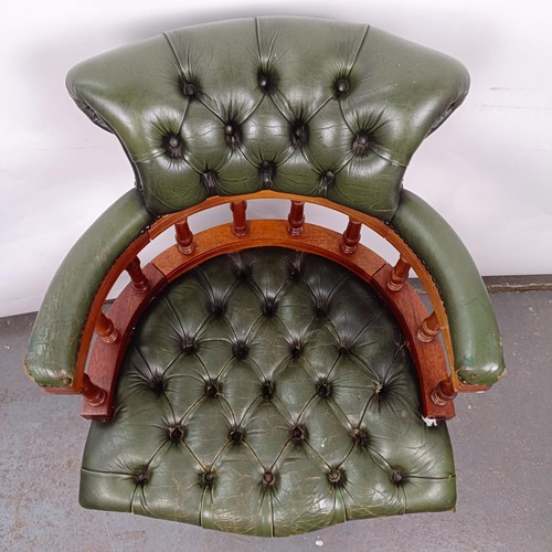 22 - A mahogany and green leather desk chair