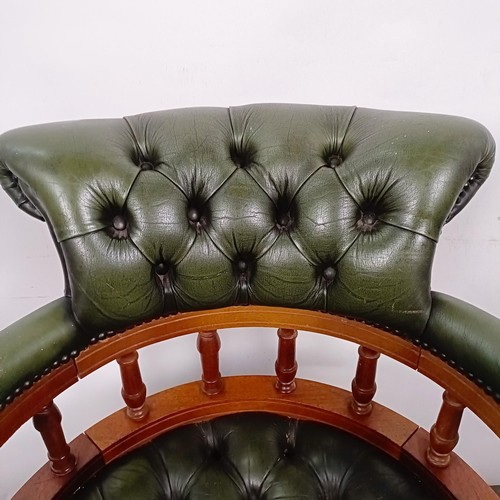 22 - A mahogany and green leather desk chair