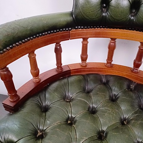 22 - A mahogany and green leather desk chair