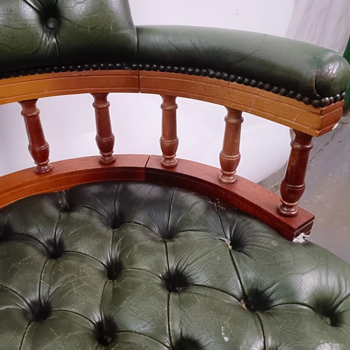 22 - A mahogany and green leather desk chair