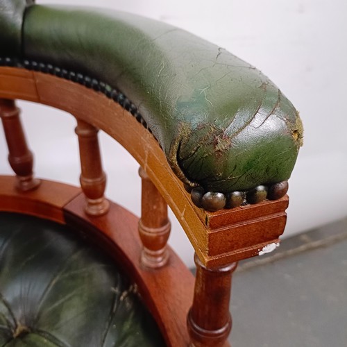 22 - A mahogany and green leather desk chair