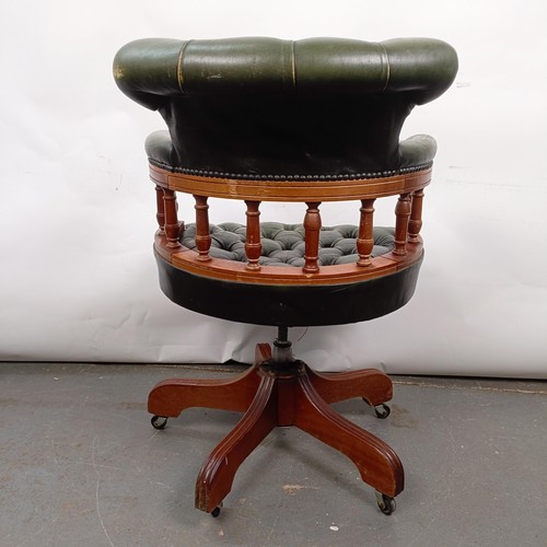 22 - A mahogany and green leather desk chair