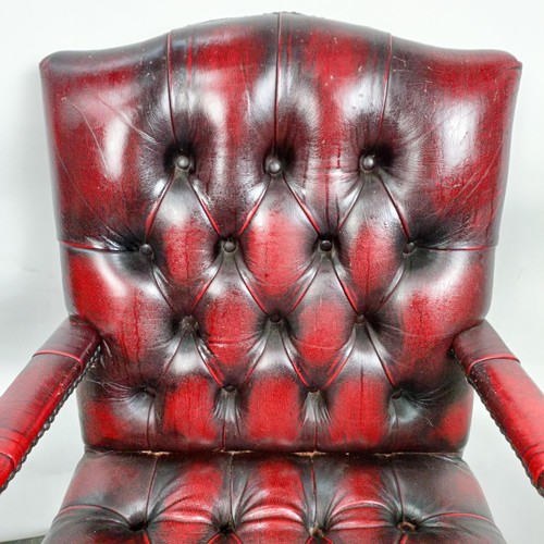 31 - A mahogany and red leather button back office chair