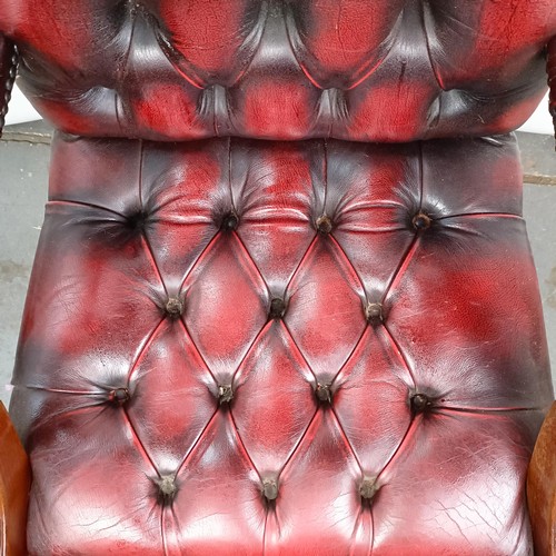 31 - A mahogany and red leather button back office chair