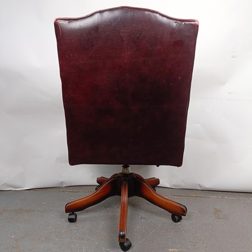 31 - A mahogany and red leather button back office chair