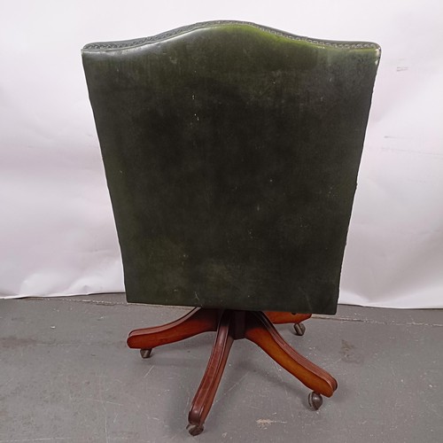 33 - A mahogany and green leather button back office chair