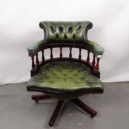 37 - A mahogany and green leather desk chair