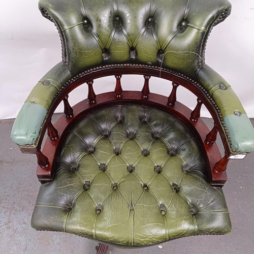 37 - A mahogany and green leather desk chair