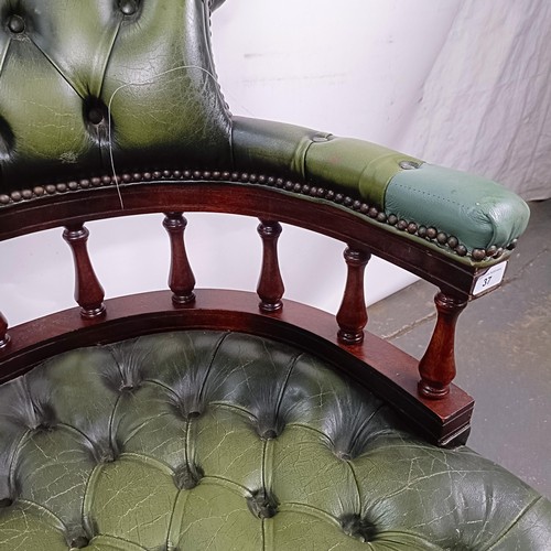 37 - A mahogany and green leather desk chair