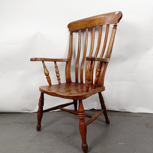 40 - A Victorian elm and beech stick back kitchen armchair