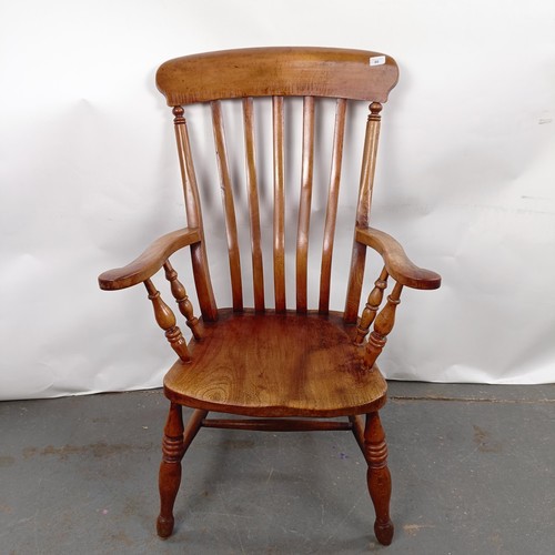 40 - A Victorian elm and beech stick back kitchen armchair