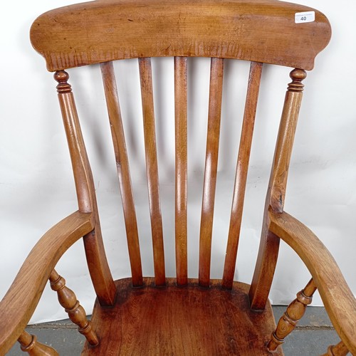 40 - A Victorian elm and beech stick back kitchen armchair