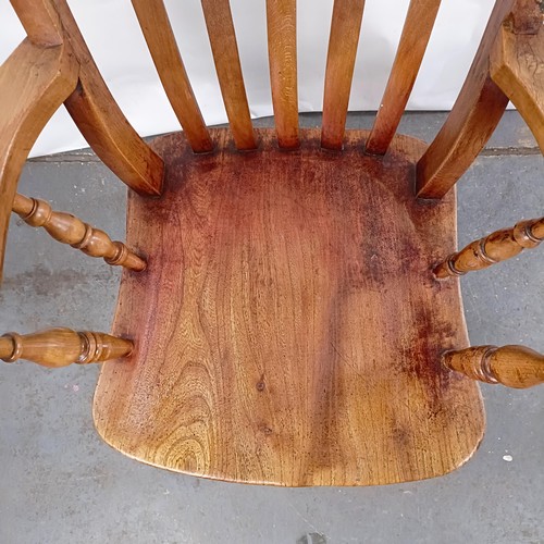 40 - A Victorian elm and beech stick back kitchen armchair