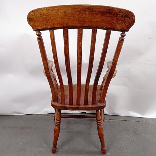 40 - A Victorian elm and beech stick back kitchen armchair