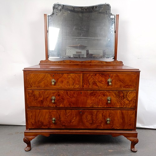 42 - A walnut dressing chest, having a mirrored back, the base with two short and two long drawers, 150 c... 