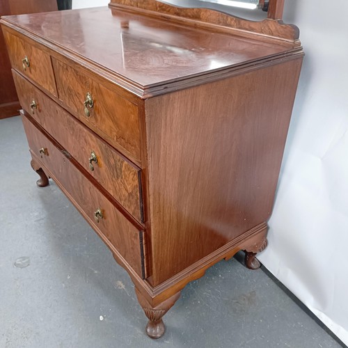 42 - A walnut dressing chest, having a mirrored back, the base with two short and two long drawers, 150 c... 