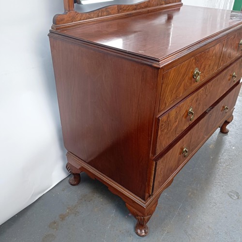 42 - A walnut dressing chest, having a mirrored back, the base with two short and two long drawers, 150 c... 