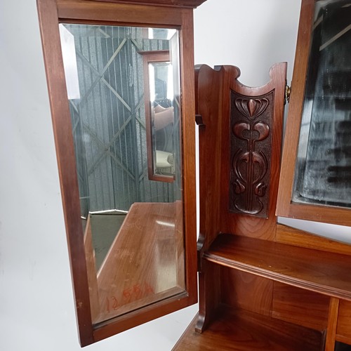 45 - An Art Nouveau style walnut dressing chest, having three long drawers, 156 cm high x 94 cm wide