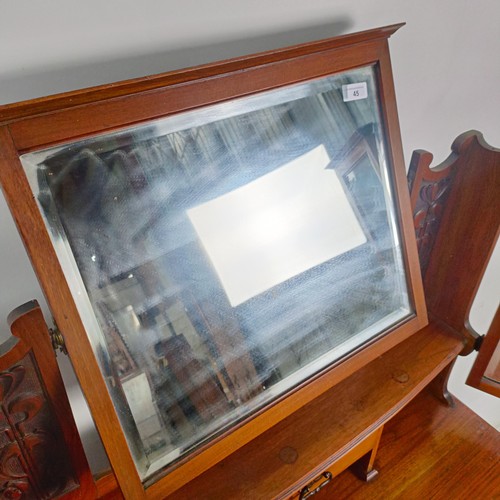 45 - An Art Nouveau style walnut dressing chest, having three long drawers, 156 cm high x 94 cm wide