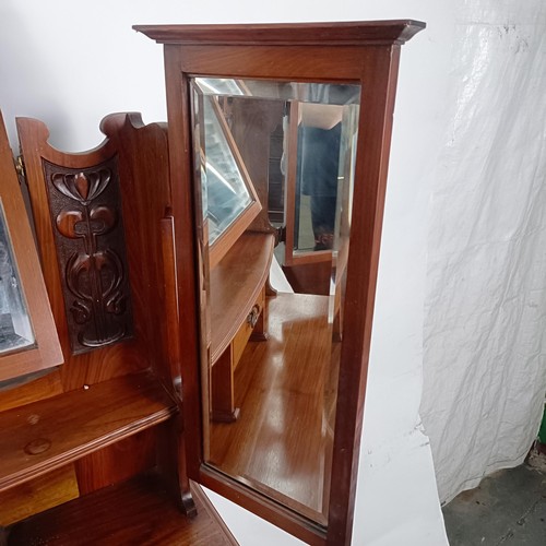 45 - An Art Nouveau style walnut dressing chest, having three long drawers, 156 cm high x 94 cm wide