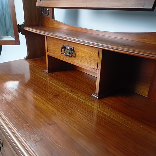 45 - An Art Nouveau style walnut dressing chest, having three long drawers, 156 cm high x 94 cm wide