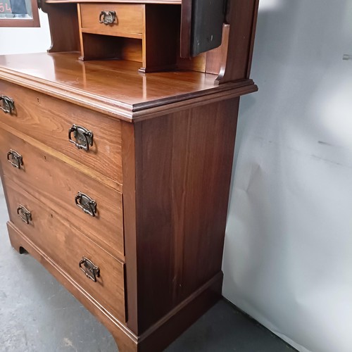 45 - An Art Nouveau style walnut dressing chest, having three long drawers, 156 cm high x 94 cm wide