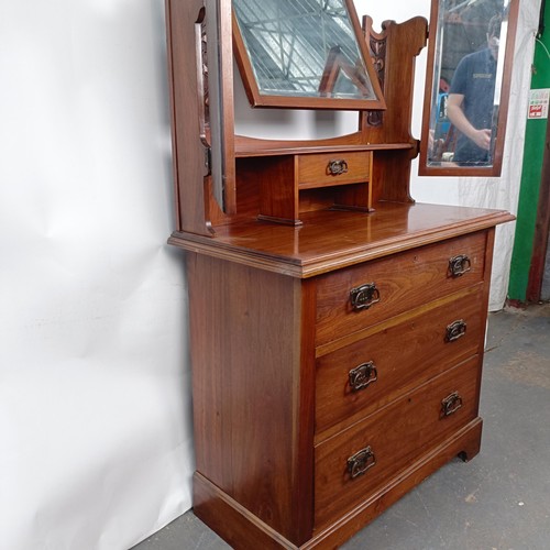 45 - An Art Nouveau style walnut dressing chest, having three long drawers, 156 cm high x 94 cm wide