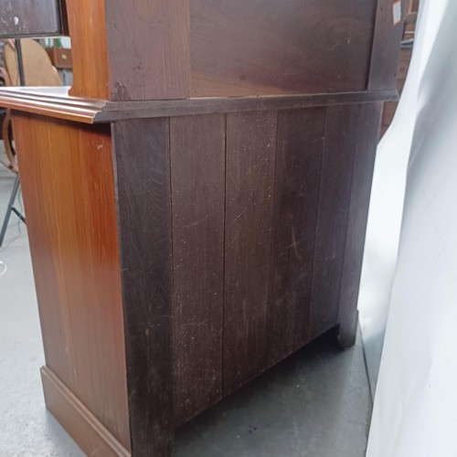 45 - An Art Nouveau style walnut dressing chest, having three long drawers, 156 cm high x 94 cm wide